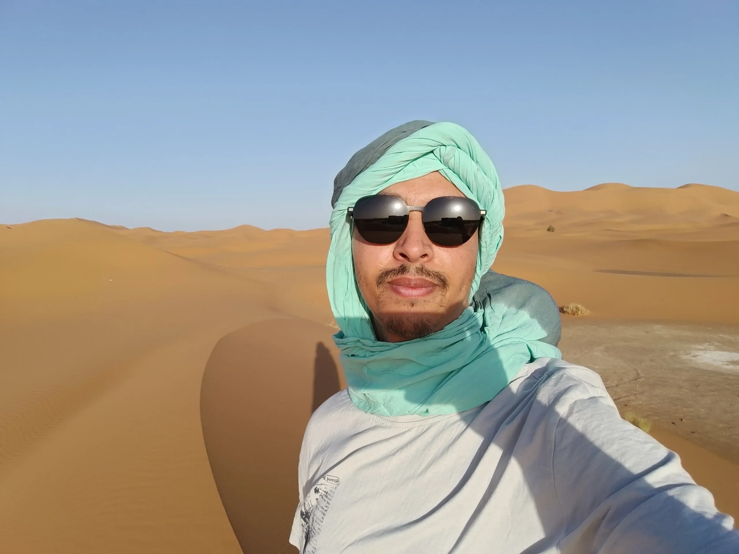 Said, founder of Ultimate Morocco Guide, in a turban in the Sahara dunes